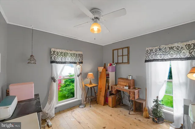 a view of a hallway with wooden floor and entryway