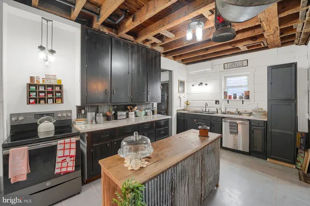 a kitchen with stainless steel appliances kitchen island granite countertop a sink and cabinets