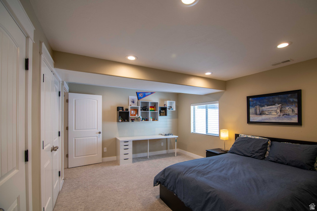 646 East 1400th Street North Mapleton, UT 84664 - Photo 55 of 78 Recessed lighting illuminates this carpeted room featuring a white paneled door, a built-in desk with drawers, and a window with blinds