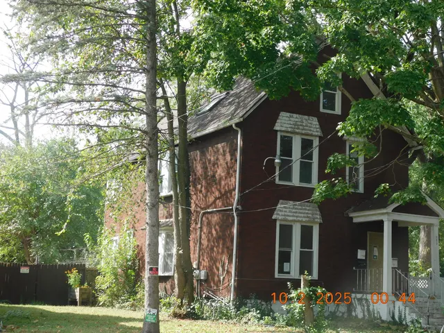 front view of a house with a tree