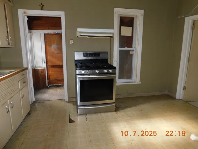 a kitchen with a stove and a cabinet