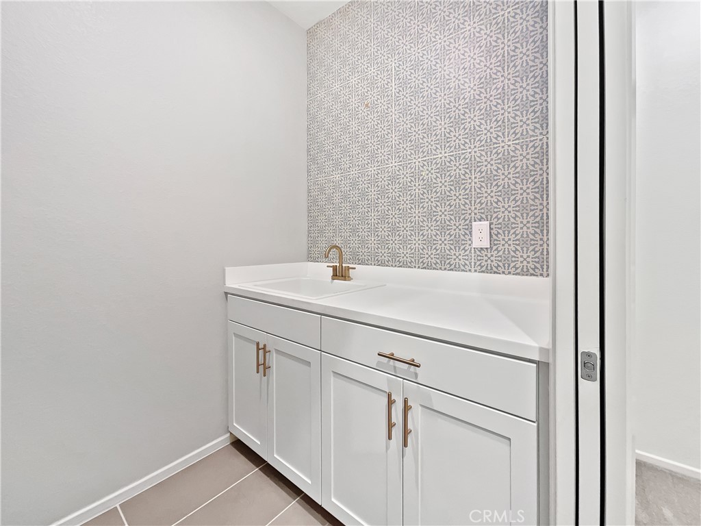 38352 Windingwalk Drive Murrieta, CA 92563 - Photo 22 of 28 a bathroom with a sink and a mirror