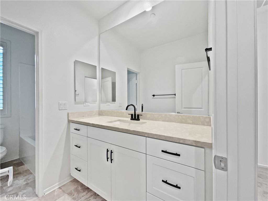 38352 Windingwalk Drive Murrieta, CA 92563 - Photo 23 of 28 a bathroom with a double vanity sink and mirror