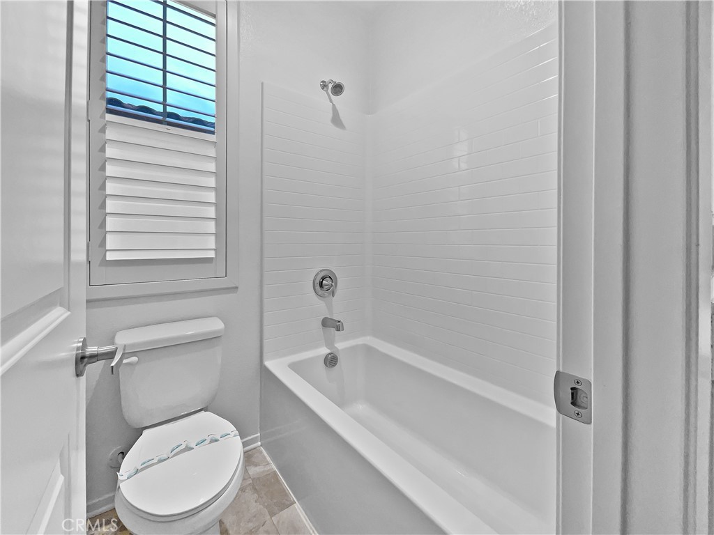 38352 Windingwalk Drive Murrieta, CA 92563 - Photo 24 of 28 a white toilet sitting next to a bath tub