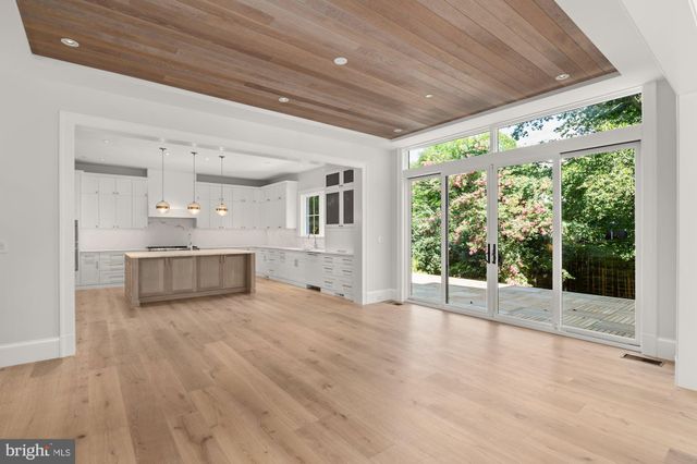 a view of a kitchen with wooden floor and a large window