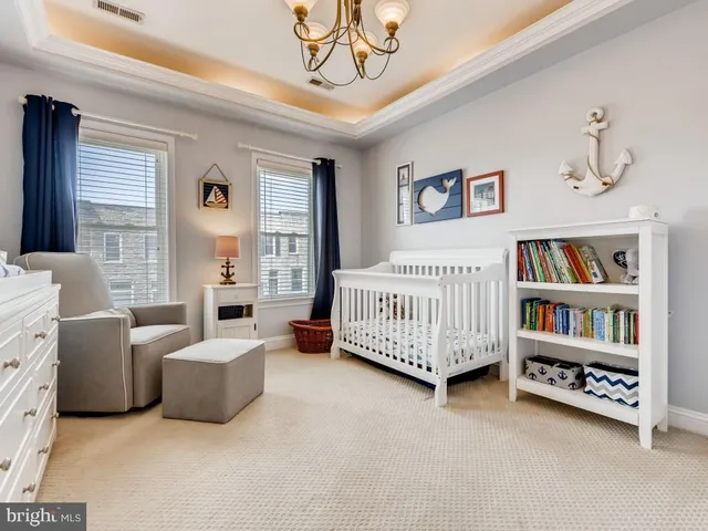 a living room with furniture and a book shelf
