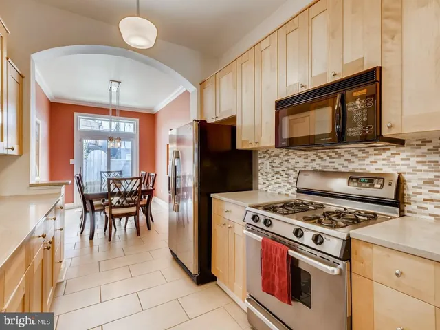 a kitchen with a stove a sink and a microwave