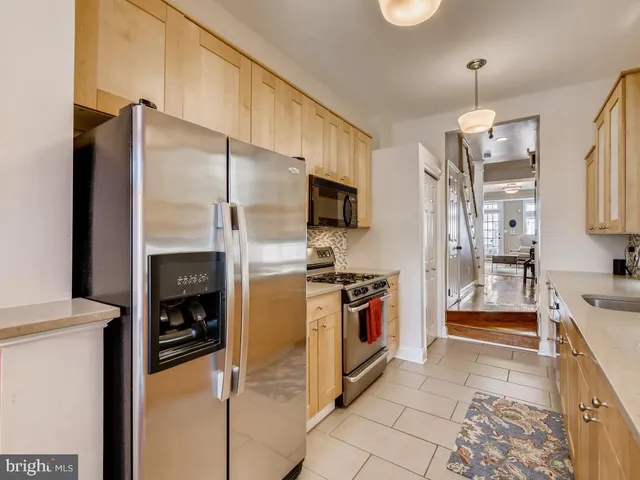 a kitchen with granite countertop a refrigerator and a stove