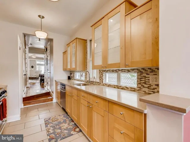 a large kitchen with kitchen island granite countertop a sink and a refrigerator
