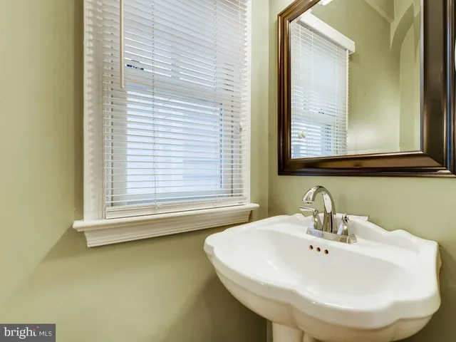 a bathroom with a sink and a window