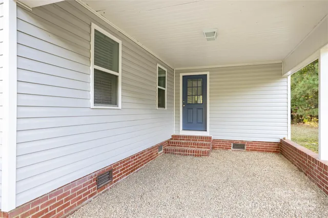 a view of house with backyard and outdoor seating