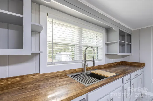 a kitchen with granite countertop a sink and a stove