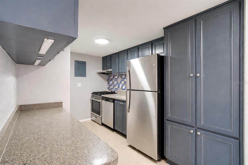 129 Blue Pointe Way, Unit 340 Altamonte Springs, FL 32701 - Photo 10 of 25 a kitchen with stainless steel appliances granite countertop a refrigerator sink and stove