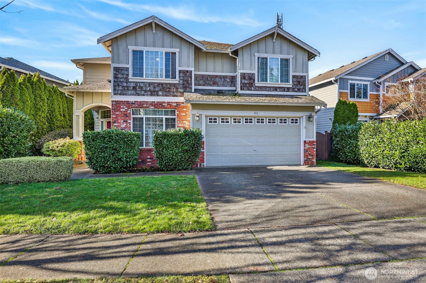a front view of a house with a yard and garage