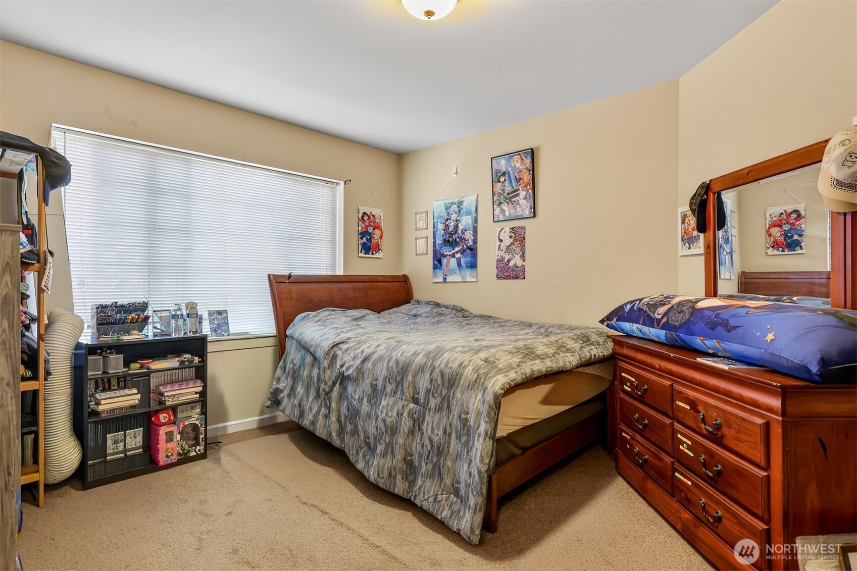 122 185th Place Southwest Bothell, WA 98012 - Photo 13 of 39 a bedroom with a bed and a dresser next to a window