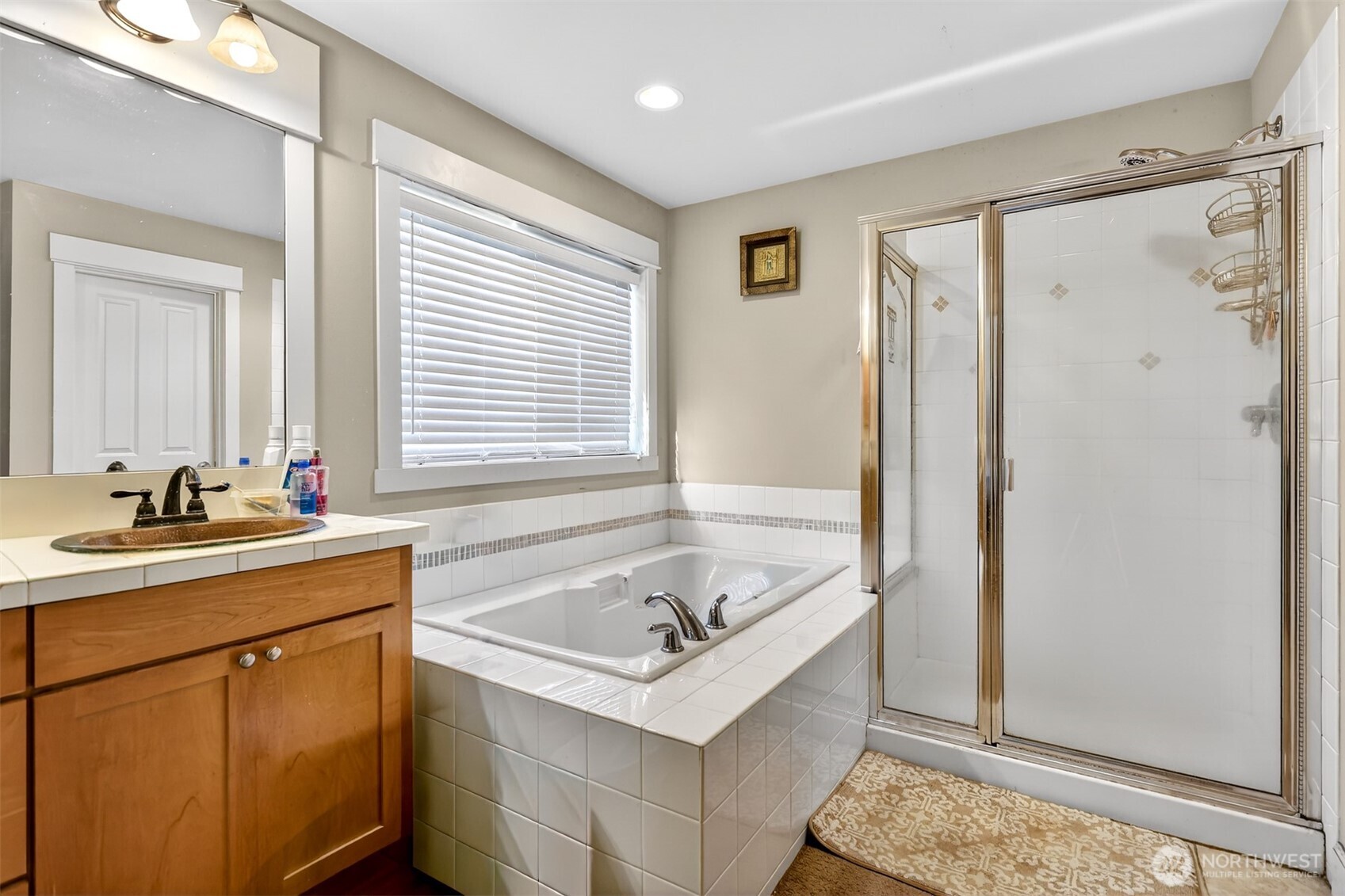122 185th Place Southwest Bothell, WA 98012 - Photo 16 of 39 a bathroom with a tub sink and mirror