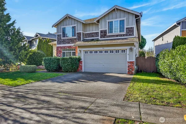 a front view of a house with a yard and garage