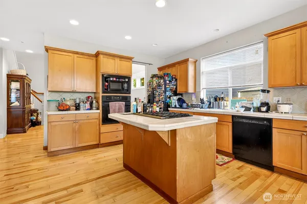 a kitchen with stainless steel appliances granite countertop a stove and a refrigerator