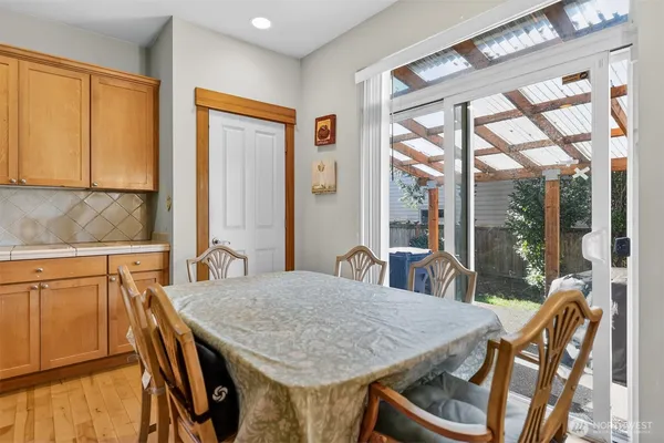 a view of a dining room with furniture large windows and wooden floor
