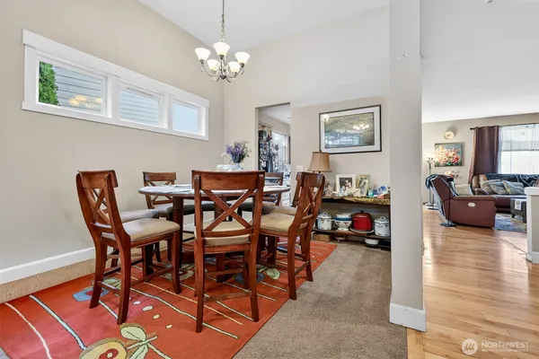 a view of a dining room with furniture and a chandelier