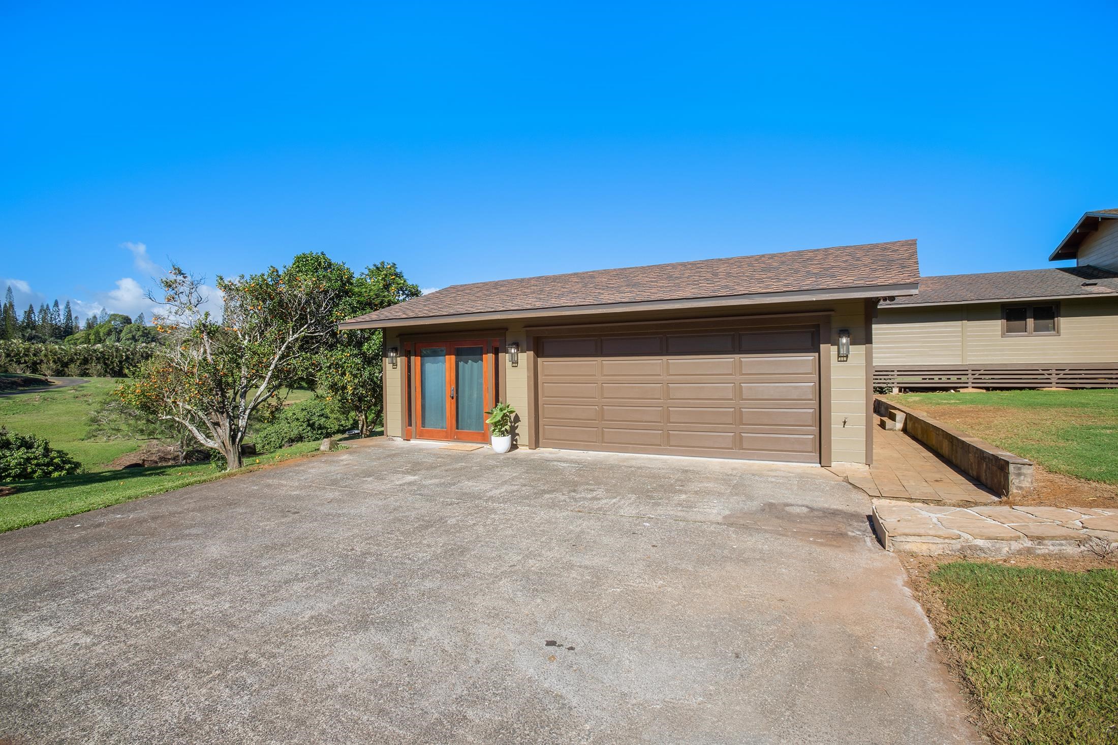 30 Mamao Place Haiku, HI 96708 - Photo 46 of 50 a front view of a house with a yard and garage