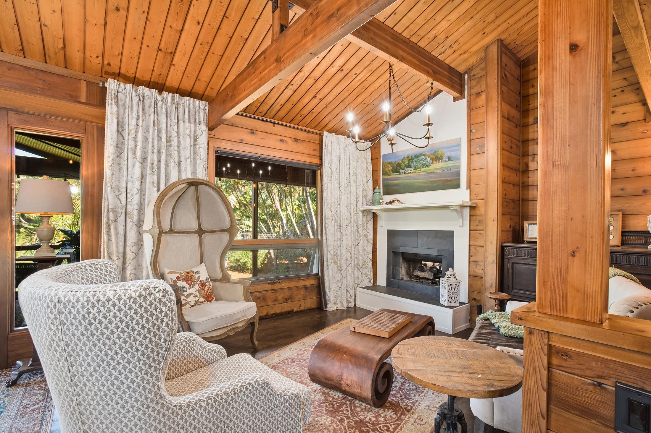 30 Mamao Place Haiku, HI 96708 - Photo 5 of 50 a living room with furniture a fireplace and a table