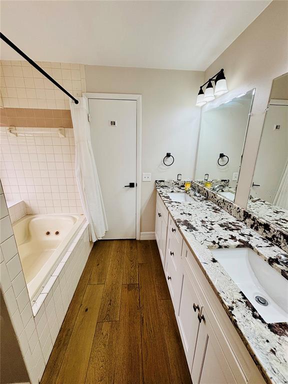 1045 Shaffer Trail Oviedo, FL 32765 - Photo 18 of 30 a bathroom with a granite countertop double vanity sink mirror double and bathtub