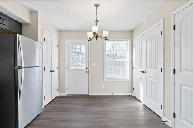 a view of kitchen with granite countertop cabinets and stainless steel appliances