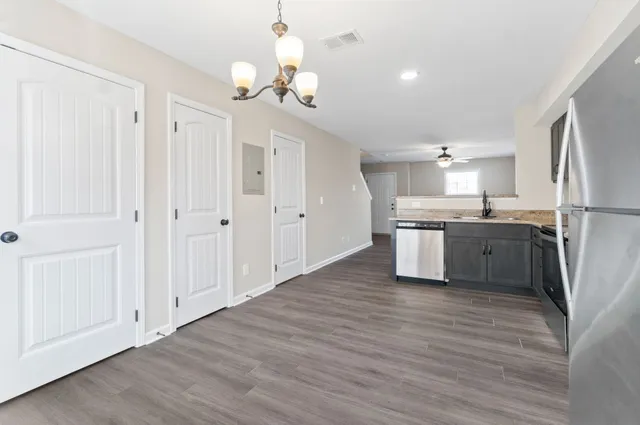 a kitchen with granite countertop stainless steel appliances a refrigerator a sink and a stove