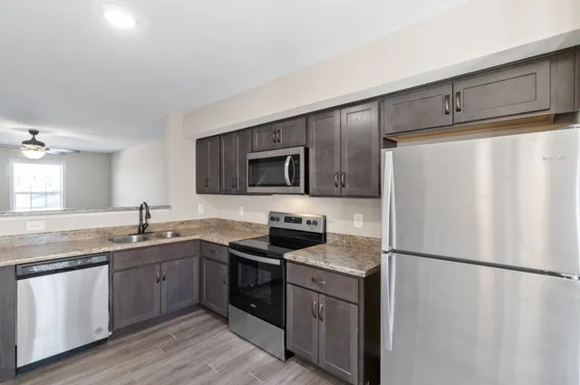 a kitchen with a refrigerator stove and sink