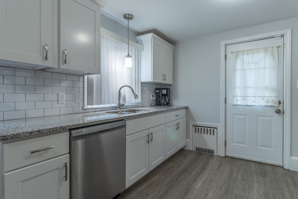 45 Baird Street Fall River, MA 02721 - Photo 11 of 42 a kitchen with white cabinets and sink