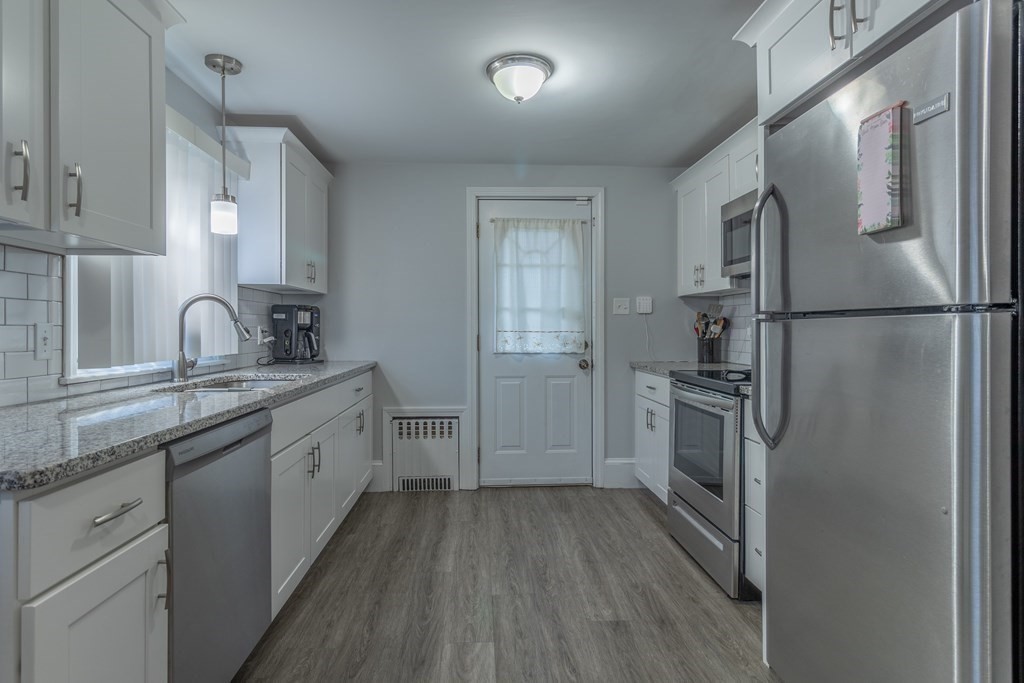 45 Baird Street Fall River, MA 02721 - Photo 12 of 42 a kitchen with a refrigerator sink and cabinets