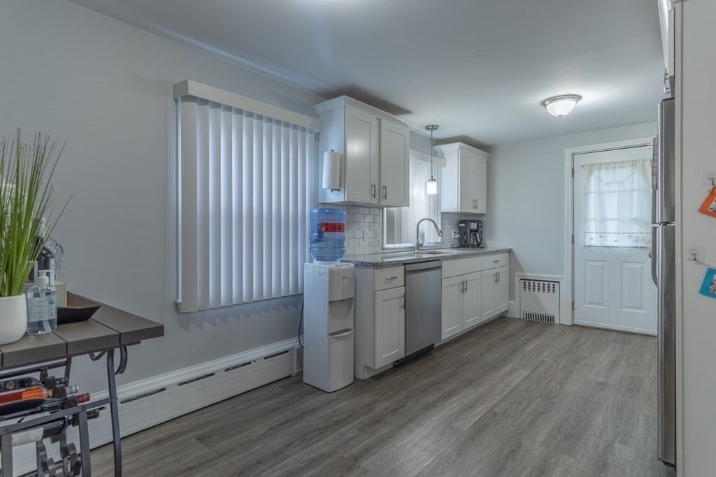 45 Baird Street Fall River, MA 02721 - Photo 13 of 42 a kitchen with a sink cabinets stainless steel appliances and a window