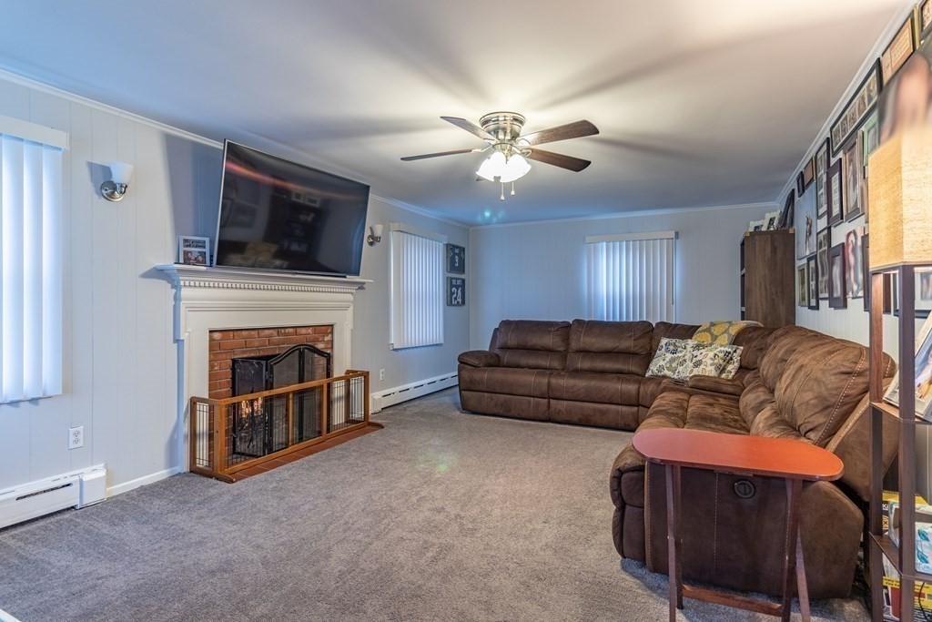 45 Baird Street Fall River, MA 02721 - Photo 15 of 42 a living room with furniture a flat screen tv and a fireplace