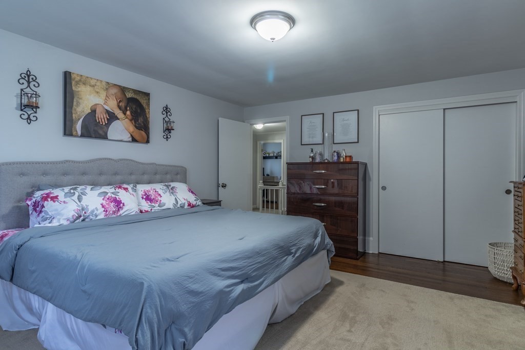 45 Baird Street Fall River, MA 02721 - Photo 26 of 42 a bedroom with a bed and a chandelier