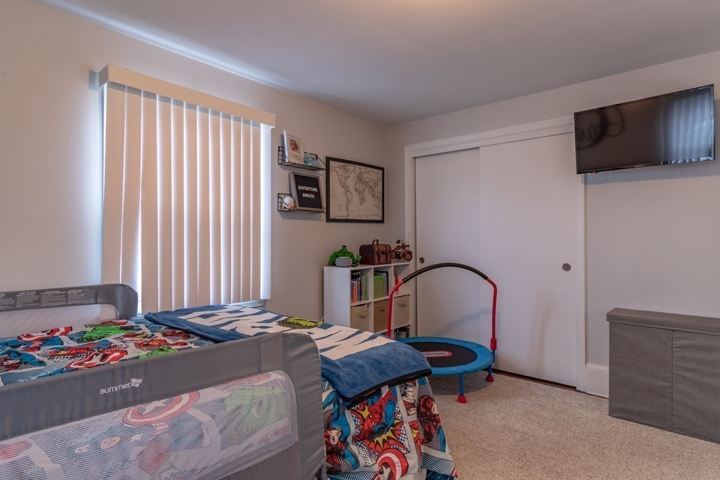 45 Baird Street Fall River, MA 02721 - Photo 28 of 42 a bedroom with a bed and a flat screen tv