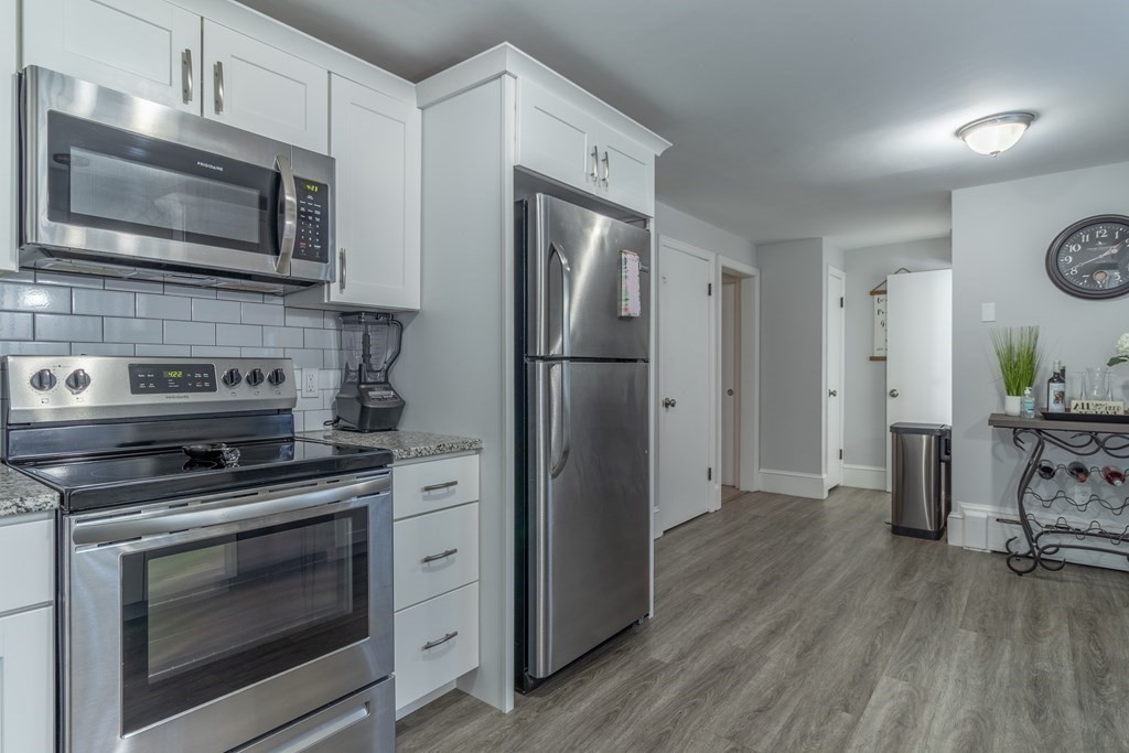 45 Baird Street Fall River, MA 02721 - Photo 8 of 42 a kitchen with a stove microwave and refrigerator