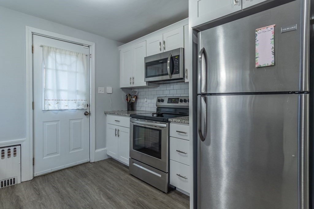 45 Baird Street Fall River, MA 02721 - Photo 10 of 42 a kitchen with stainless steel appliances a refrigerator microwave and sink