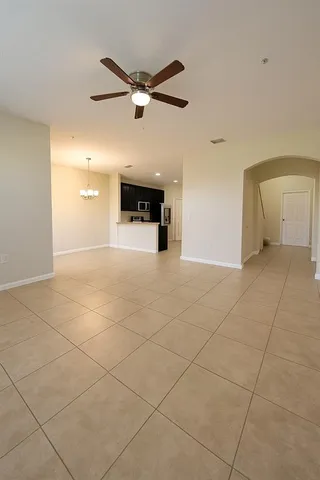 a view of a livingroom with a ceiling fan and window