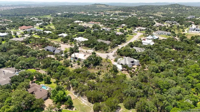 an aerial view of residential houses with city view