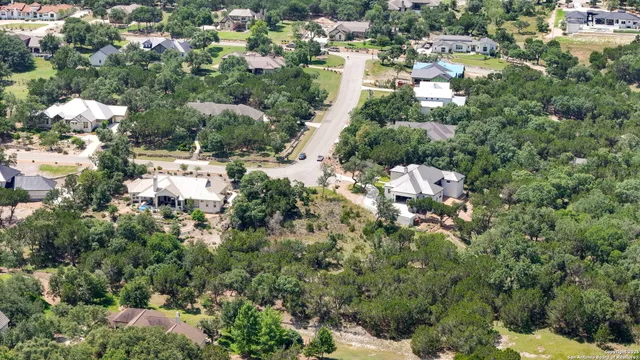 an aerial view of residential house with parking space and trees