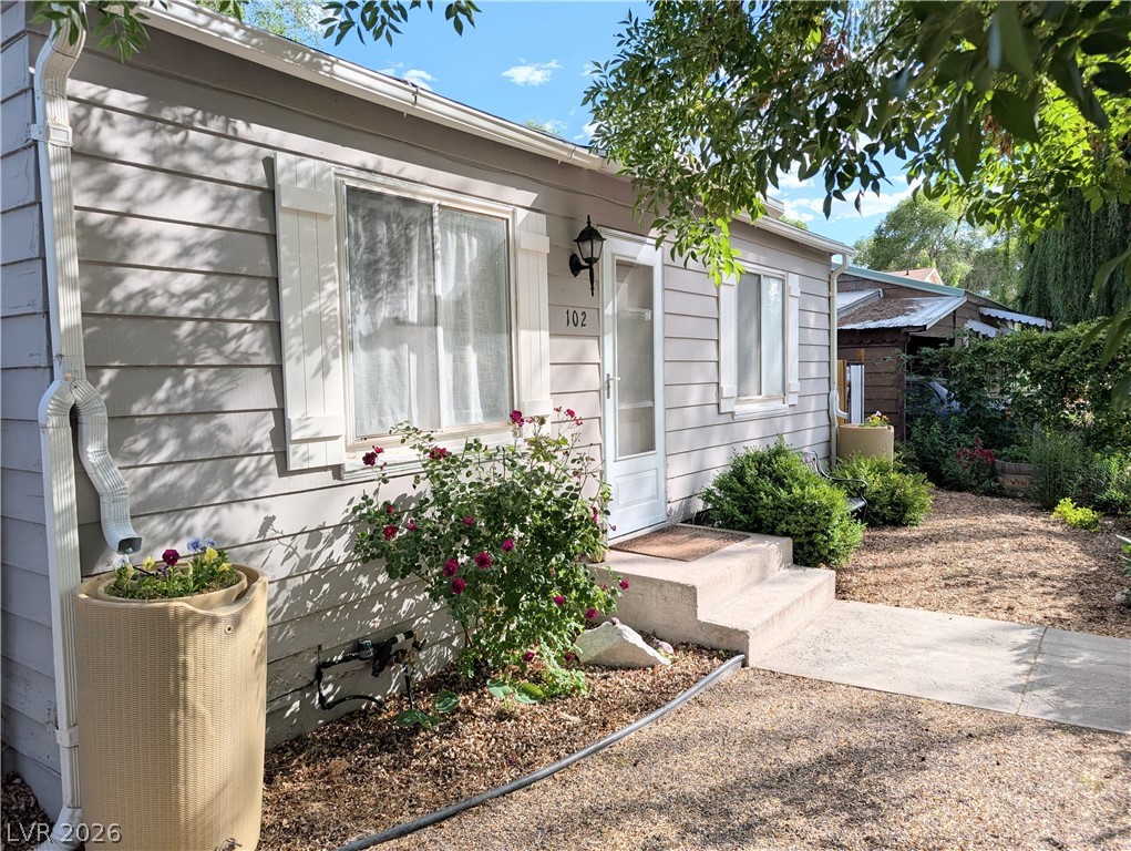 A charming cottage facade, well-tended landscaping enhancing its curb appeal.