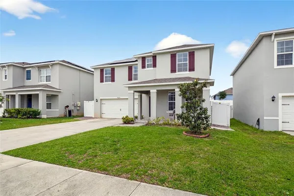a front view of a house with a yard