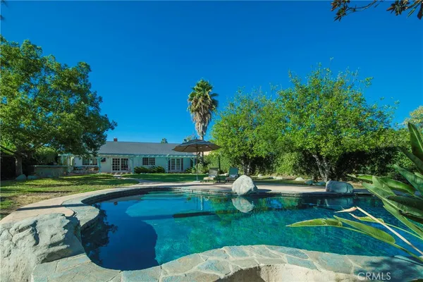 a view of a swimming pool with a garden