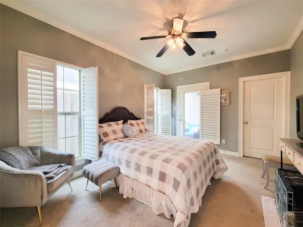 a bedroom with a bed a couch and a large window