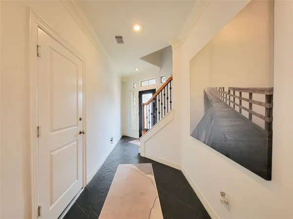a view of entryway and hall with wooden floor