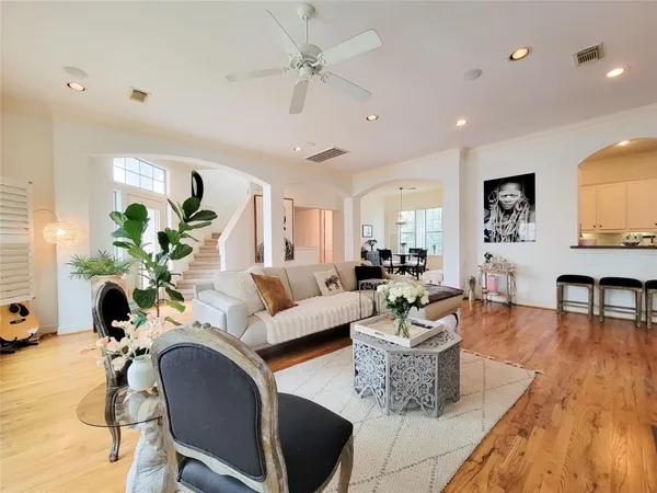 a living room with furniture potted plant and a chandelier