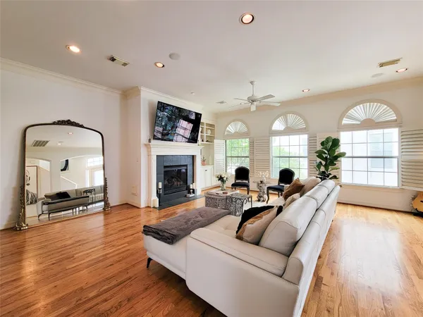 a living room with furniture fireplace and a large window