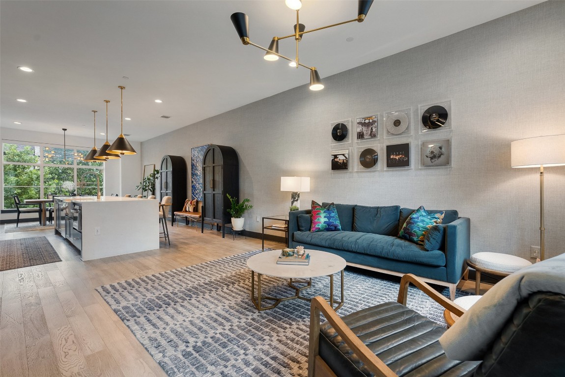 4507 Unity Circle Austin, TX 78731 - Photo 11 of 37 Living area with light wood-type flooring, recessed lighting, and arched walkways