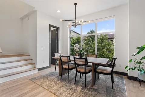 a large kitchen with stainless steel appliances kitchen island a large stove a sink dishwasher and a fireplace with wooden floor